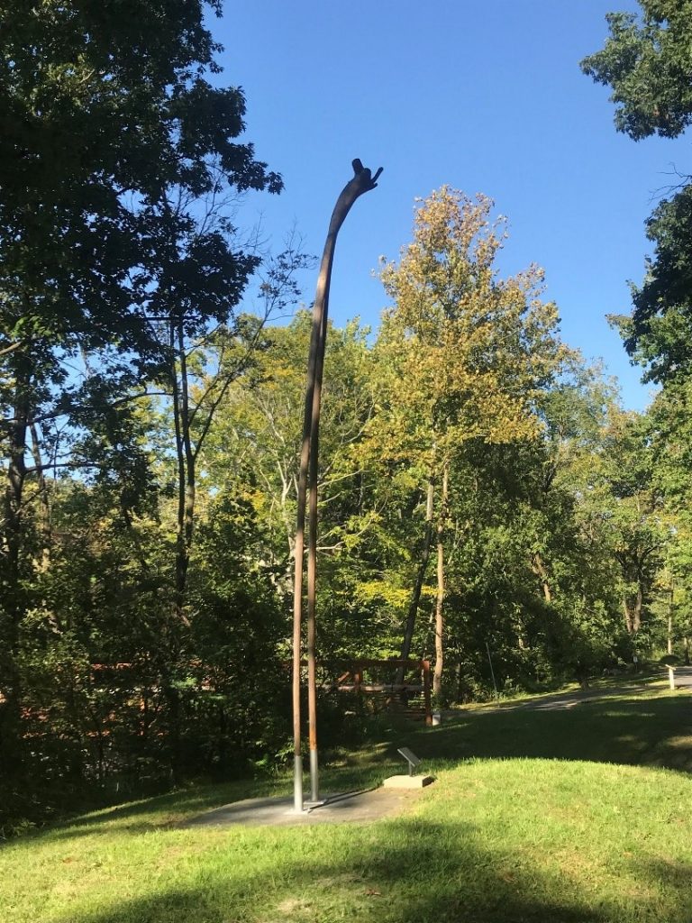 The sculpture Alien by Loren Madsen, with two trunks of a tree flipped so the root are on top, on the Karl Stirner Arts Trail in Easton, Pennsylvania.
