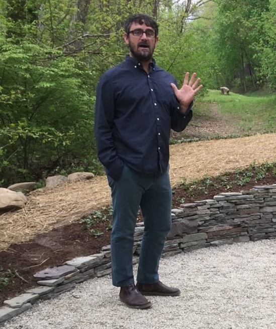 Paul Deery stands at his stone Water Way installation and talks on the Karl Stirner Arts Trail in Easton, Pennsylvania.