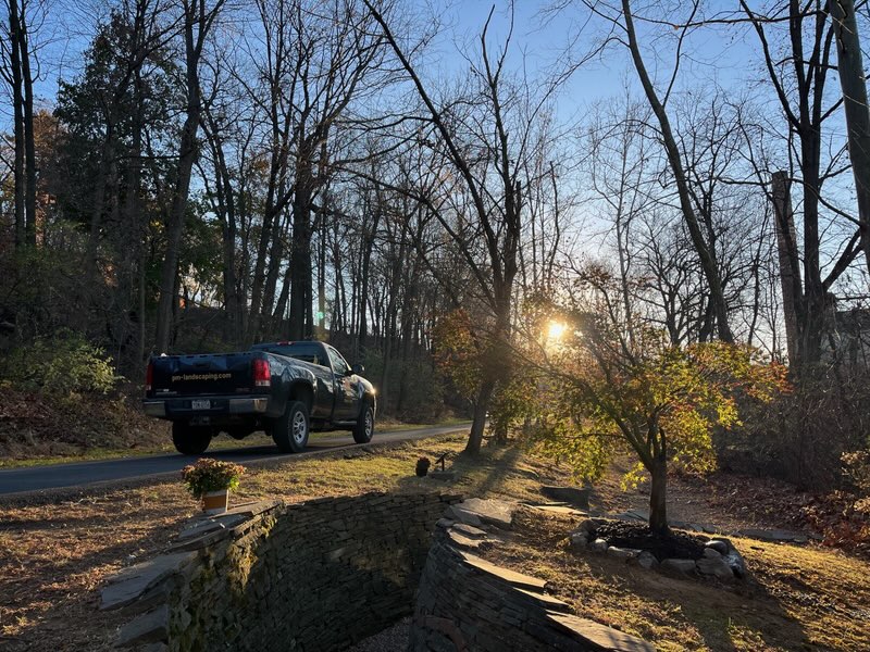 A PM Landscaping pickup truck is parked by the Water Way installation created by the late Paul Deery, along with a newly replanted split leaf maple tree on the Karl Stirner Arts Trail in Easton, Pennsylvania.