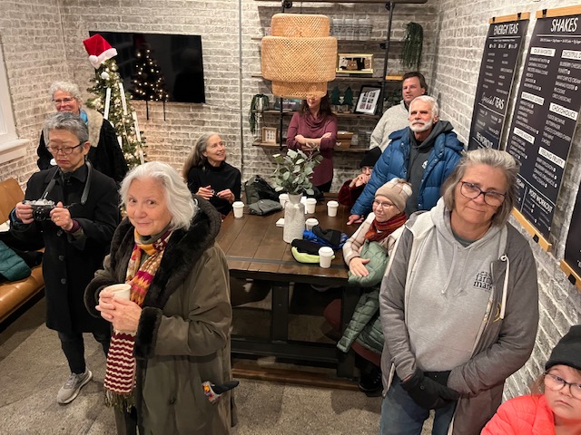 A group of people inside the Thrive store enjoy the Winter Solstice event.