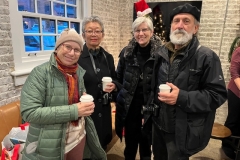 Four people  inside the Thrive store enjoy the Winter Solstice event.