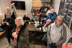 A group of people inside the Thrive store enjoy the Winter Solstice event.