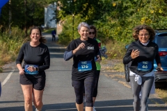 Three women run side by side at the Artful Dash 5K Run/Walk on the Karl Stirner Arts Trail in Easton, Pennsylvania.