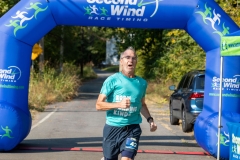 A running man crosses the finish line at the Artful Dash 5K Run/Walk on the Karl Stirner Arts Trail in Easton, Pennsylvania.