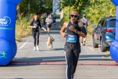 A woman runs by the finish line at the Artful Dash 5K Run/Walk on the Karl Stirner Arts Trail in Easton, Pennsylvania.