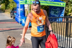 A man holds hands with a young girl at the Artful Dash 5K Run/Walk on the Karl Stirner Arts Trail in Easton, Pennsylvania.