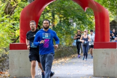 Racers run near the iconic red arch sculpture at the Artful Dash 5K Run/Walk on the Karl Stirner Arts Trail in Easton, Pennsylvania.