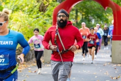 Racers run past the iconic red arch sculpture  at the Artful Dash 5K Run/Walk on the Karl Stirner Arts Trail in Easton, Pennsylvania.