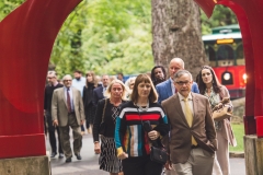 Lafayette President Alison Byerly and a crowd of people walking through the red arch sculture en route to the gala.