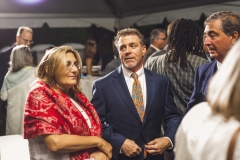 Jim Toia and others stand under a tent  at the Karl Stirner Arts Trail gala.