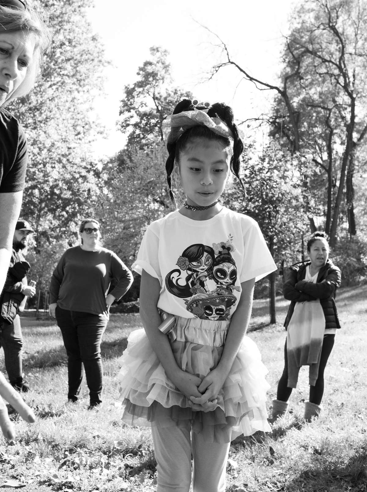 A girl wearing a T-shirt and a skirt stands A young girl wearing a costume walks at the annual Come as You Art event on the Karl Stirner Arts Trail.