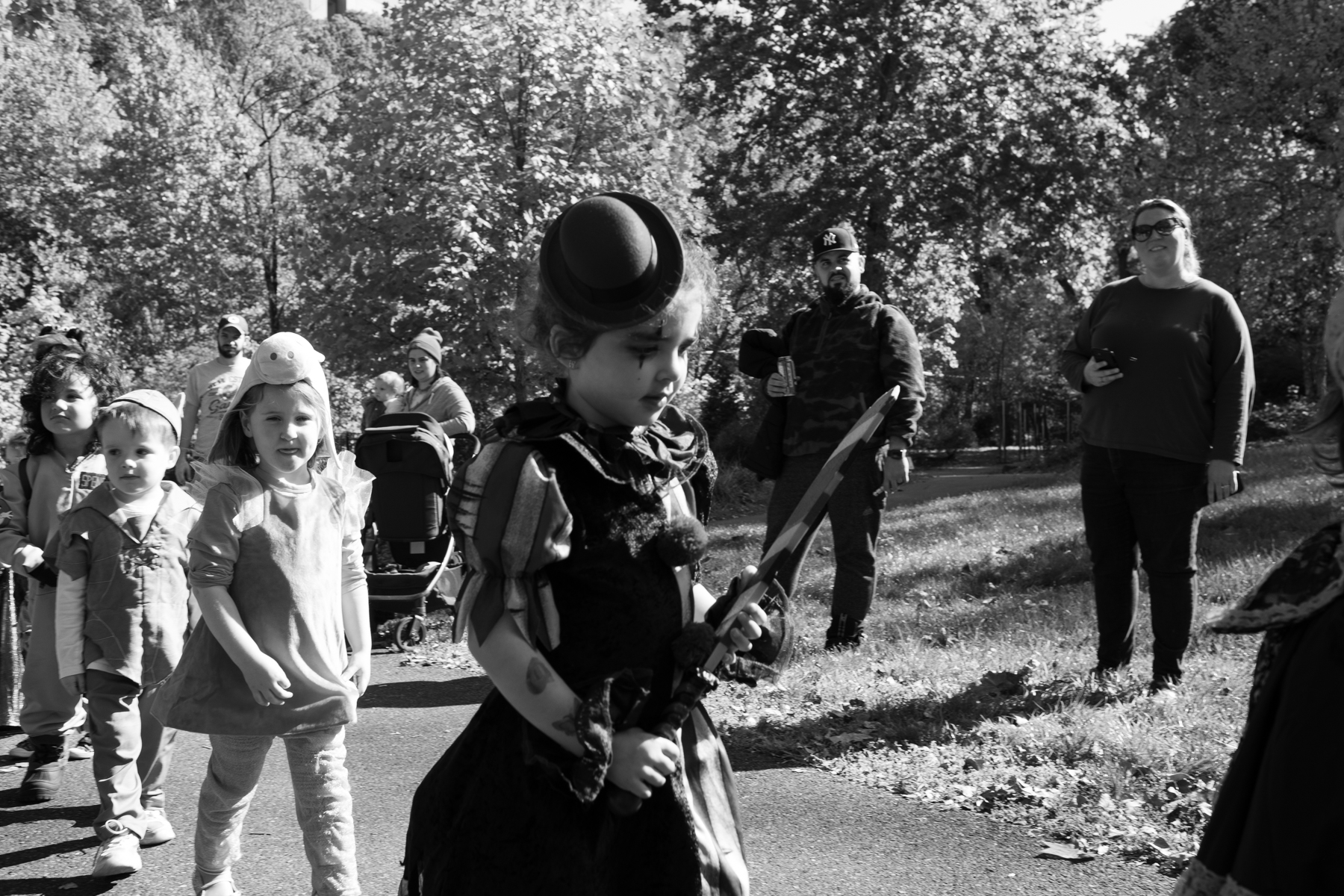 A young girl wearing a costume walks at the annual Come as You Art event as parents watch on the Karl Stirner Arts Trail.