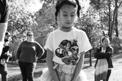 A girl wearing a T-shirt and a skirt stands A young girl wearing a costume walks at the annual Come as You Art event on the Karl Stirner Arts Trail.