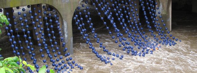 Big blue beads from the Bushkill Curtain installation dip into Bushkill Creek on the Karl Stirner Arts Trail