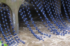 Big blue beads from the Bushkill Curtain installation dip into Bushkill Creek on the Karl Stirner Arts Trail