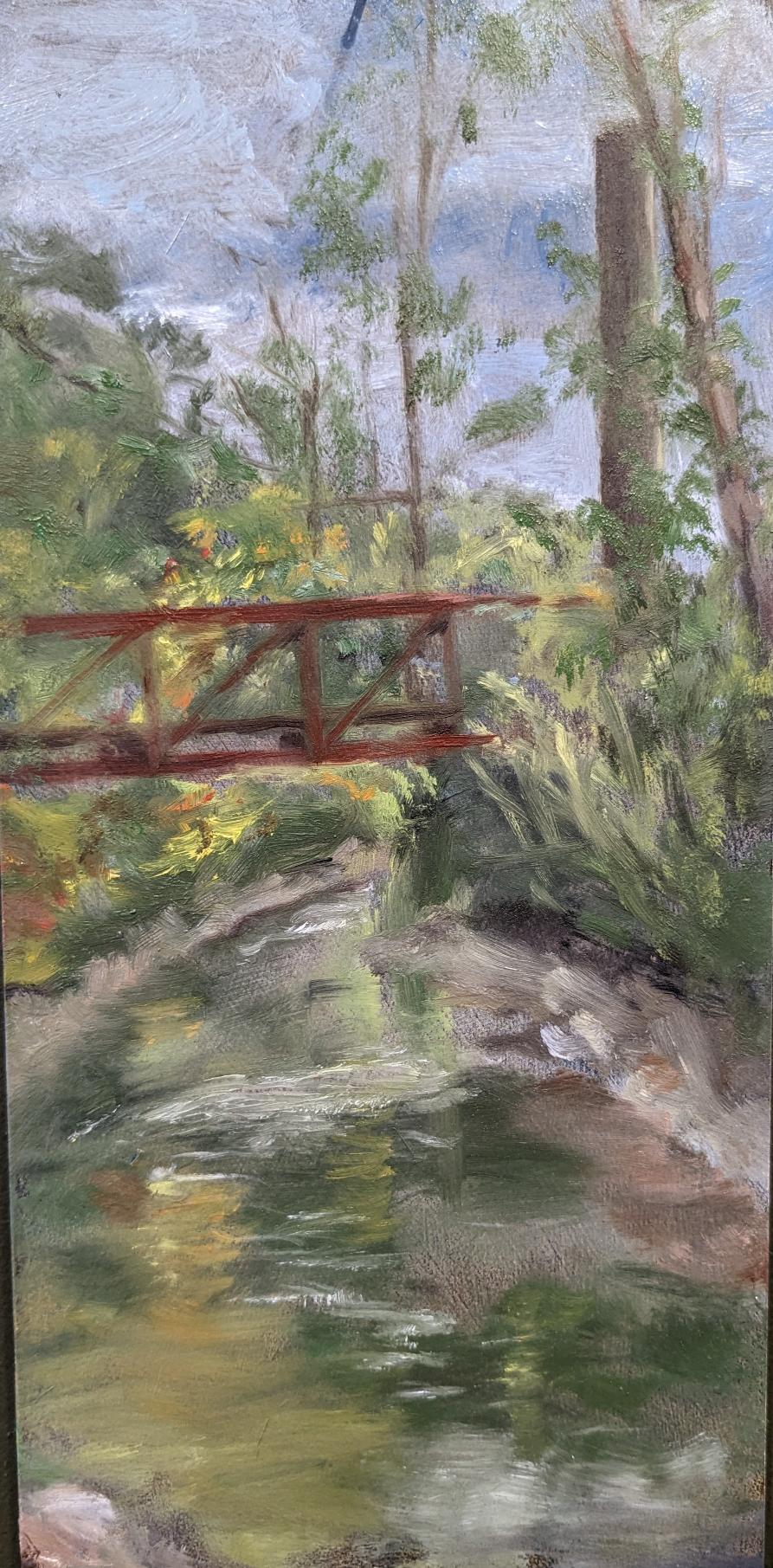 A plein air painting by Cindy Vojnovic of trees and a pedestrian bridge at the Karl Stirner Arts Trail in Easton, Pennsylvania