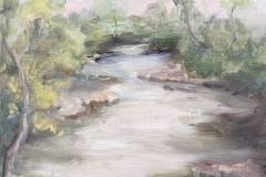 A plein air painting by Carol Magnatta of Bushkill Creek with trees and vegetation on the banks