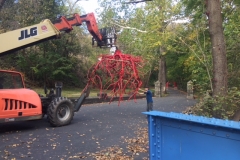 Works use machinery in the installation of the Steve Tobin sculpture Late Bronze Root on the Karl Stirner Arts Trail.