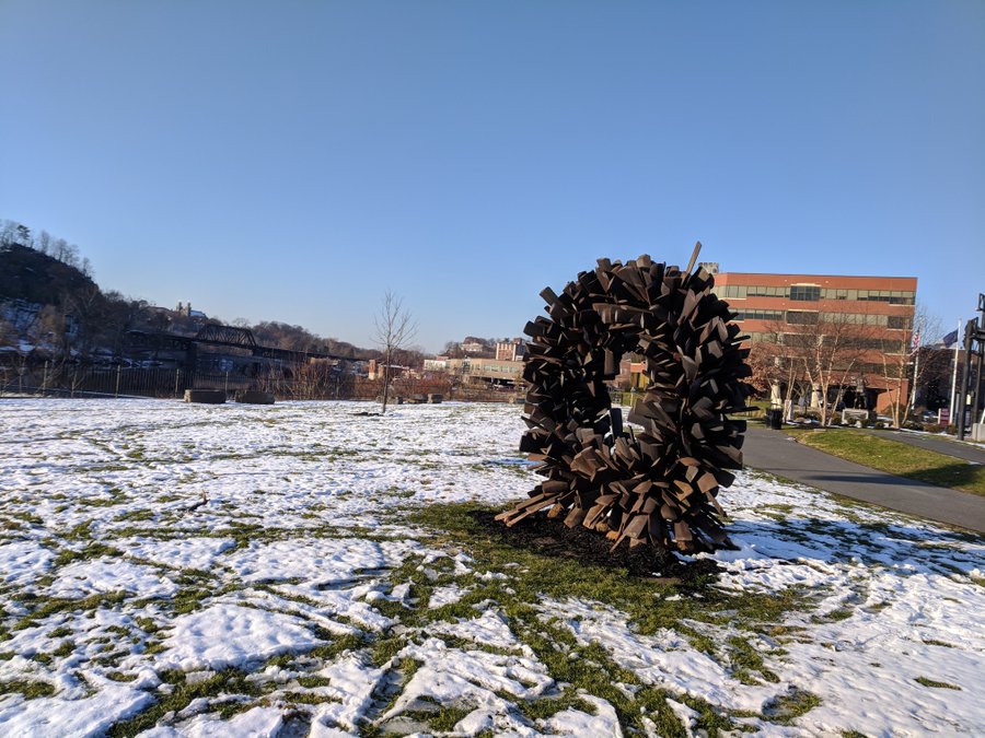 The Steve Tobin sculpture wreath stands with snow-covered ground around it