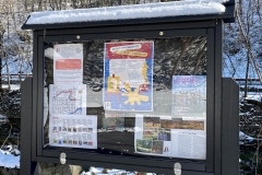 A message board with flyers in it on the Karl Stirner Arts Trail