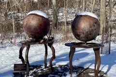 The sculpture Nitrogen and Hydrogen has snow on the top at the Karl Stirner Arts Trail.