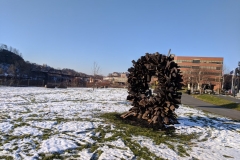 The Steve Tobin sculpture wreath stands with snow-covered ground around it
