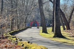 Trees and the Karl Stirner Arts Trail with the iconic red arch sculpture in the distance