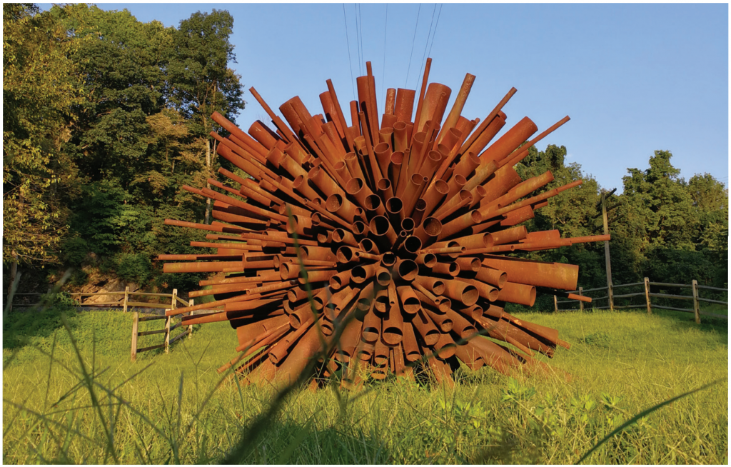 The sculpture Corymb Exploding by Steve Tobin, which has many pieces of scrap metal put together in a ball shape, stands at Hugh Moore Park in Easton, Pennsylvania.