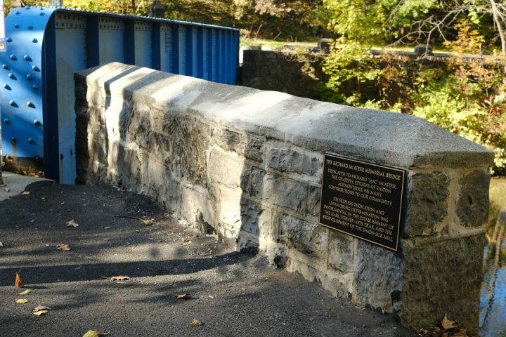 The formerly named Blue Bridge and the plaque marking its rededication as the Richard McAteer Memorial Bridge on the Karl Stirner Arts Trail in Easton, Pennsylvania