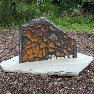 Made of rock and cast iron, the sculpture called Upriver: Mudcracks, one of five pieces in the Upriver installation by artist Heidi Wiren Bartlett, stands on the Karl Stirner Arts Trail in Easton, Pennsylvania.