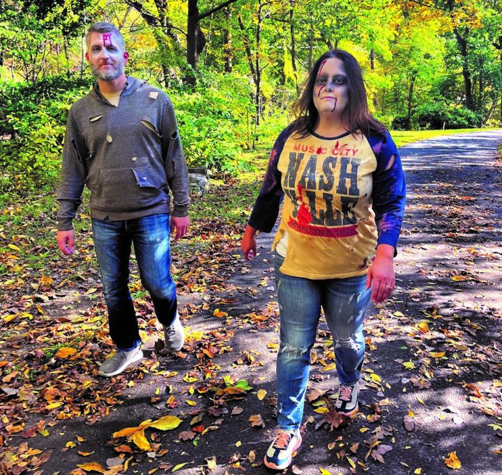 A man and a woman, both with zombie-type makeup, walk on the Karl Stirner Arts Trail in Easton, Pennsylvania.
