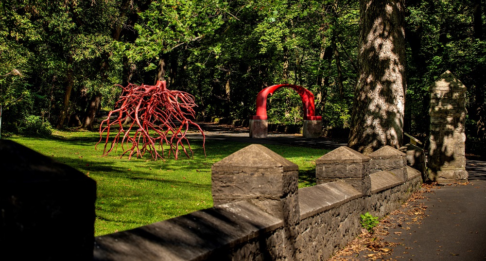 The red arch and Late Bronze Root sculptures on the Karl Stirner Arts Trail in Easton, Pennsylvania