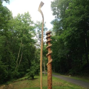 The wooden sculpture Nobori by Loren Madsen, consisting of two poles, one of which looks like a screw in the top half, on the Karil Stirner Arts Trail in Easton, Pennsylvania