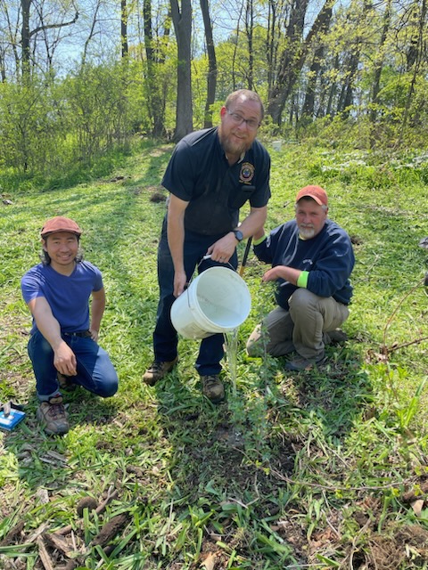 Pawpaw master Philip Chung and City of Easton Parks and Recreation employees Kyle Leh & Robert Kaegy take a break for a photo during their planting and watering of a pawpaw tree on the Karl Stirner Arts Trail in Easton, Pennsylvania.
