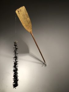 The artwork Pa'rriba/pa'bajo (not far now) by Karl Stirner Arts Trail artist in residence Nestor Gil features a wooden paddle attached to a piece of fishing line that has butterflies through it.