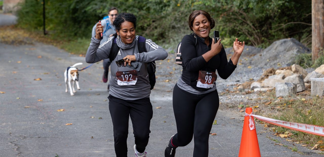 Two women joggers laugh during the Artful Dash 5K Run/Walk on the Karl Stirner Arts Trail in Easton, Pennsylvania.