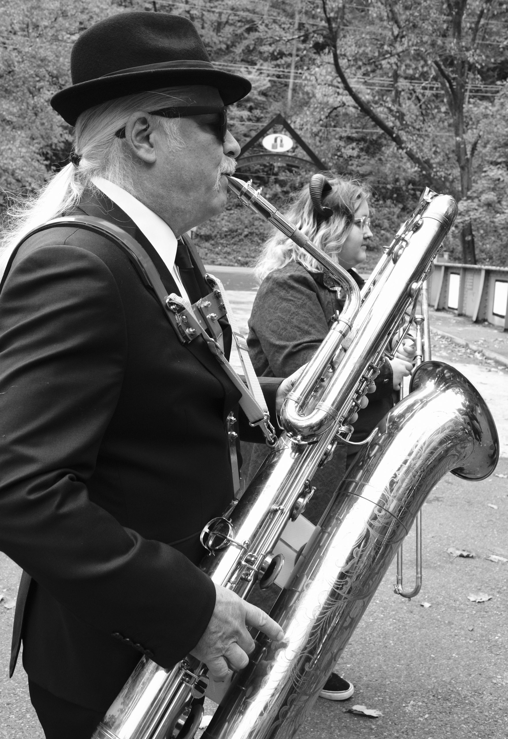 A baritone sax player in the Big Easy Easton Brass band performs at the Come As You Art/Arf costume parade on the Karl Stirner Arts Trail in Easton, Pennsylvania.