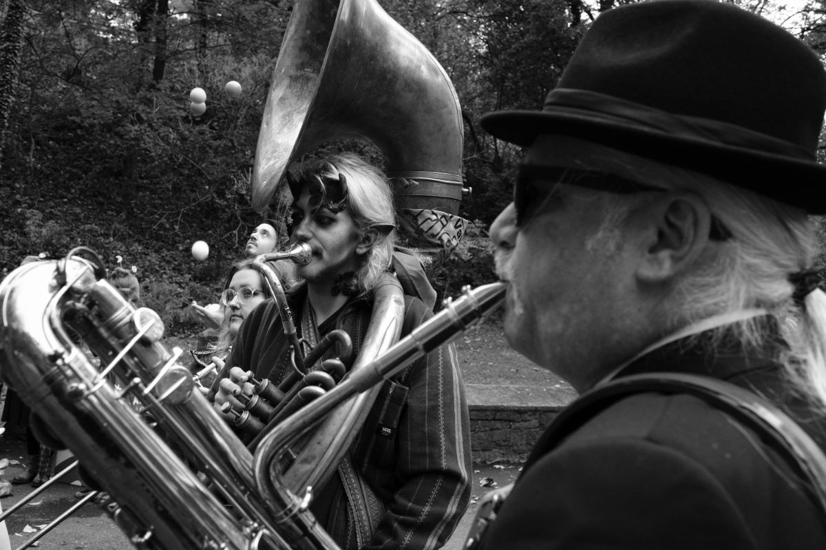 A sousaphone player and a saxophone player in the Big Easy Easton Brass band perform and walk at the Come As You Art/Arf children's and pet costume parade on the Karl Stirner Arts Trail in Easton, Pennsylvania.