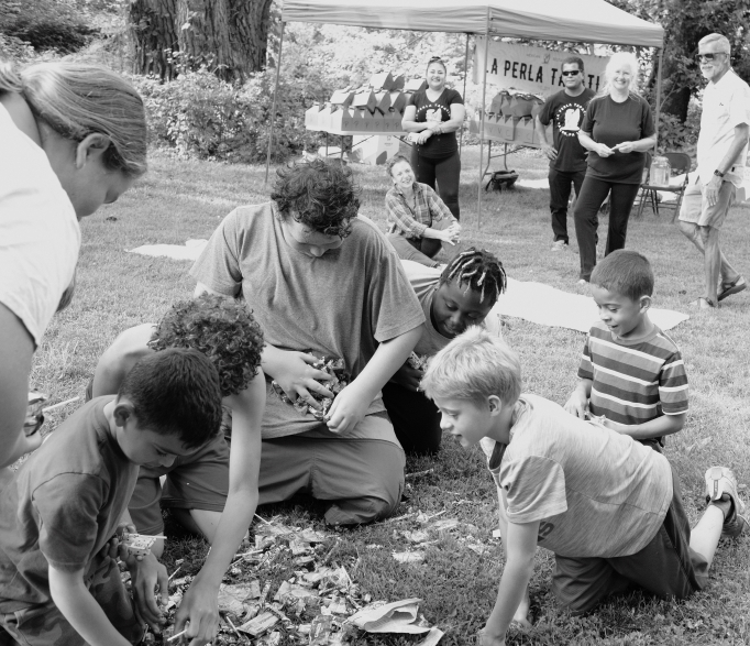 Children grab candy from the ground that fell from a conquered piñata during the LaJiraGira community picnic on the Karl Stirner Arts Trail in Easton, Pennsylvania.