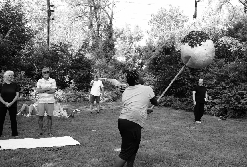 A girl hits a piñata during the LaJiraGira community picnic on the Karl Stirner Arts Trail in Easton, Pennsylvania.