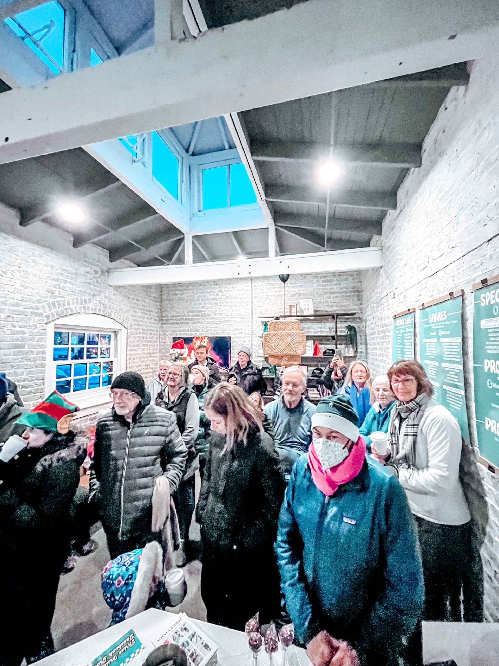 People stand indoors at the Winter Solstice Walk hosted by Thrive Easton and the Karl Stirner Arts Trail in Easton, Pennsylvania.