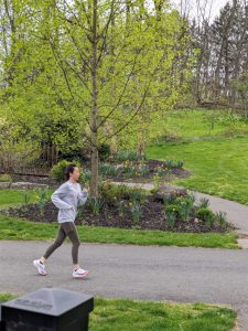 A woman runs on Pink flowers on the Karl Stirner Arts Trail in Easton, Pennsylvania.
