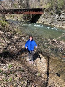 A Lafayette College student stands by Bushkill Creek during a cleanup of the Karl Stirner Arts Trail in Easton, Pennsylvania.