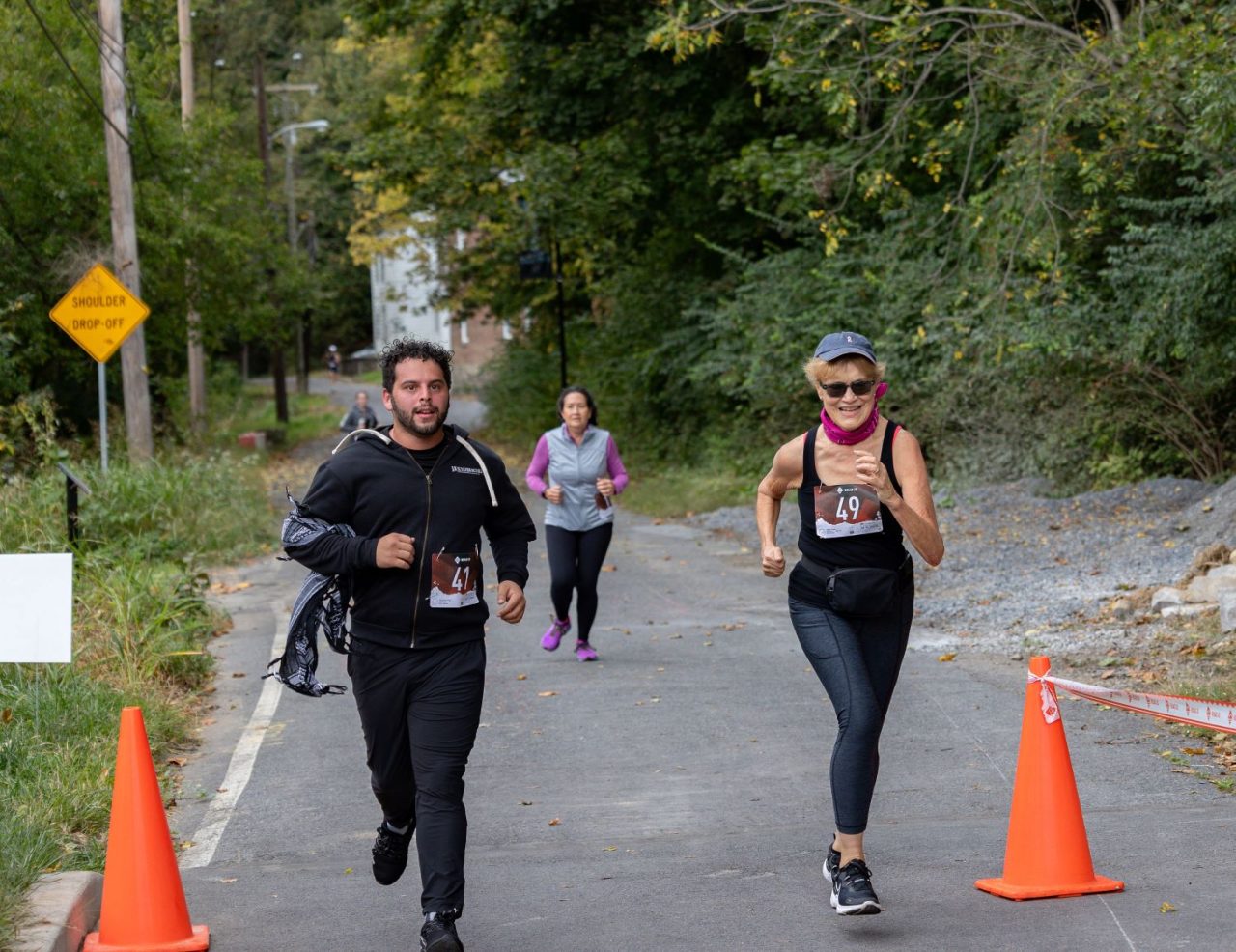 A man and a woman run during the Sixth Annual Artful Dash 5K Run/Walk on the Karl Stirner Arts Trail in Easton, Pennsylvania.