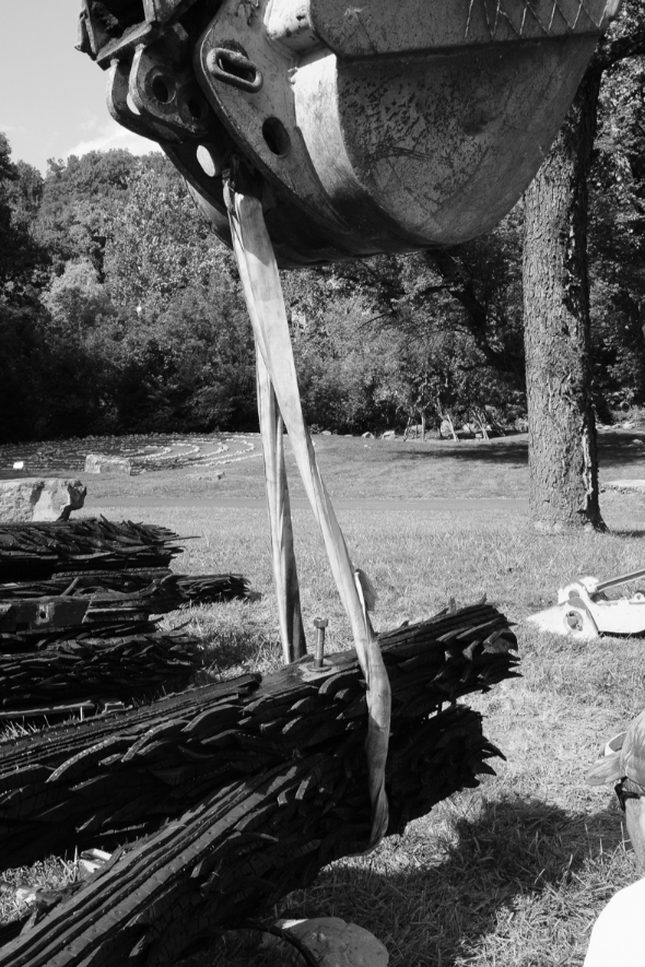 A rope has been placed around a portion of recycled rubber tire for the installation of Chakaia Booker's sculpture, No More Milk and Cookies, on the Karl Stirner Arts Trail in Easton, Pennsylvania.