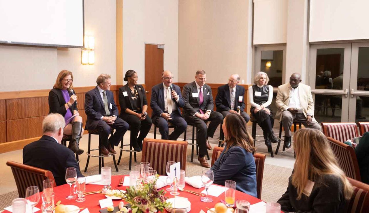 Jim Toia, Gladstone Hutchinson, Easton Mayor Sal Panto, Lafayette College President Nicole Hurd, and several other people participate in a panel discussion at Lafayette College.